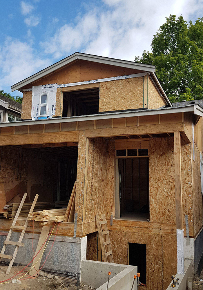 Exterior view of home under construction with walls installed