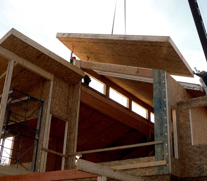 Structural Insulated Panels being lowered onto frame